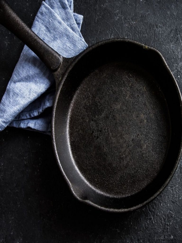 resized image of black cast iron pan with blue towel